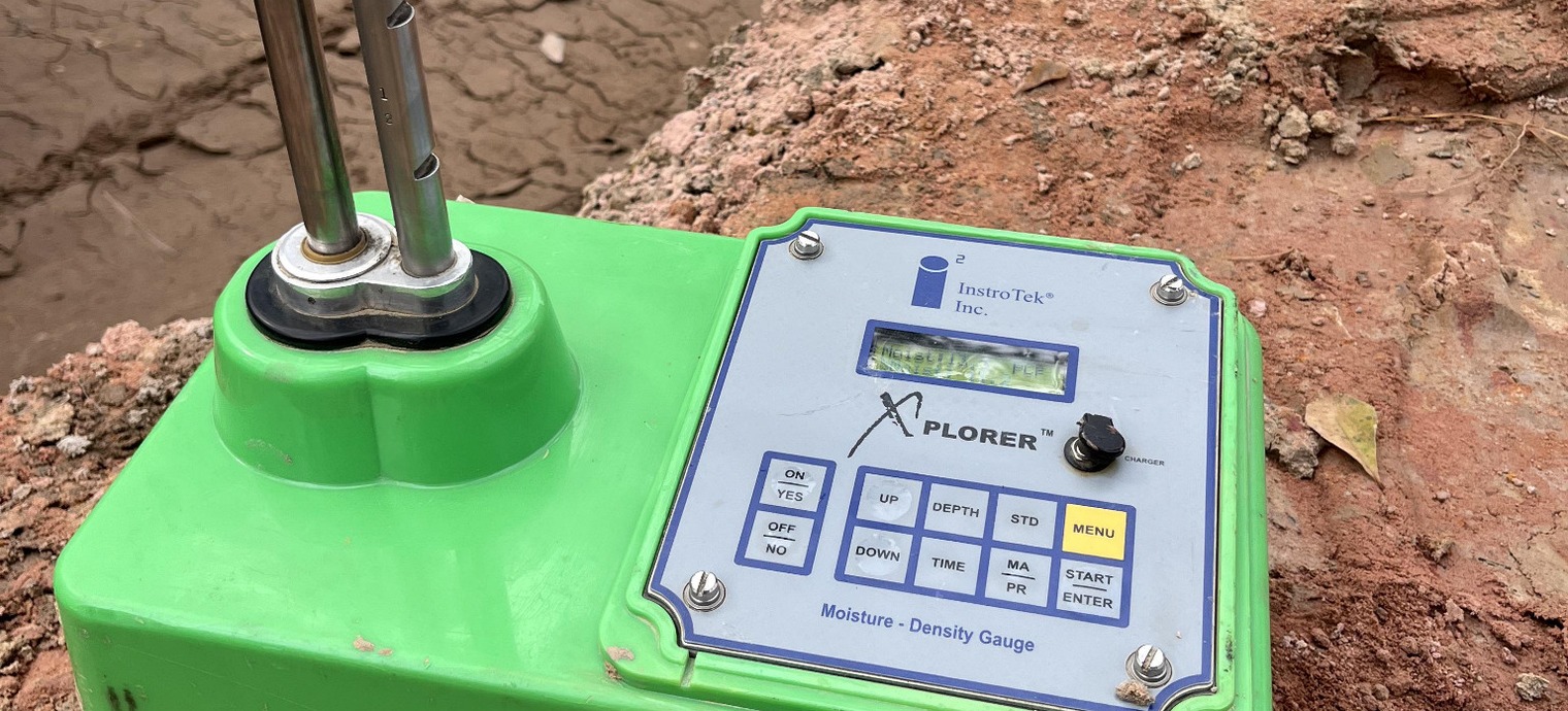Portable moisture-density gauge at a construction site